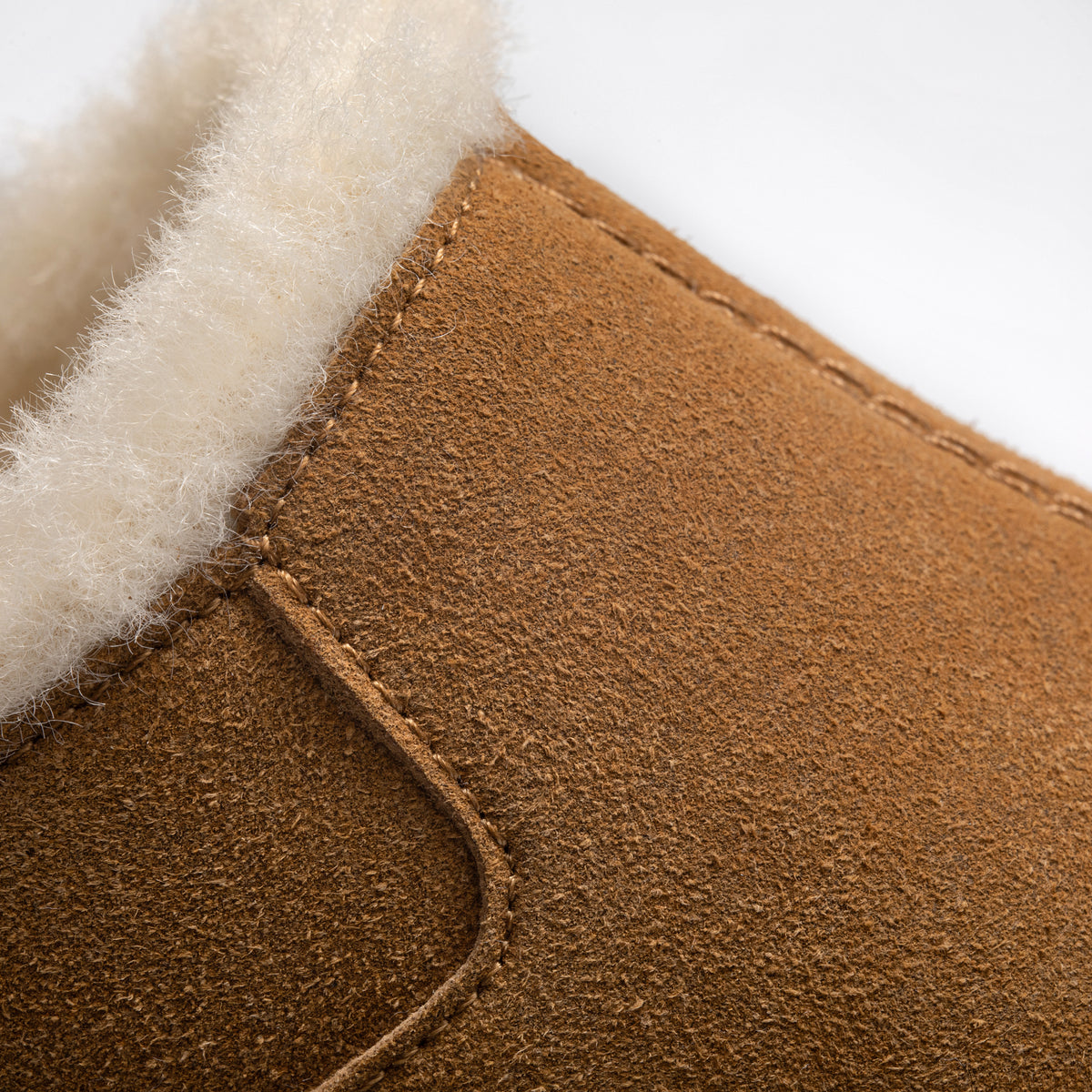 Close-up detail of PCSsole brown suede arch support slip-on slippers, showing the texture and stitching.