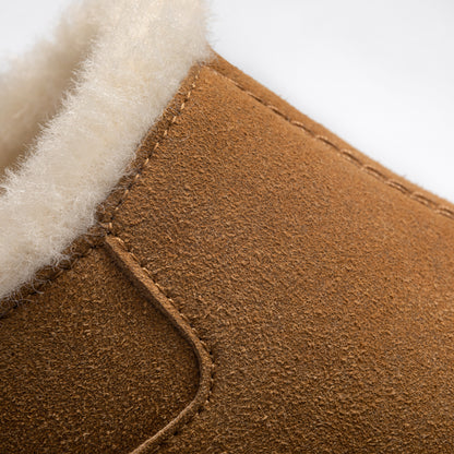 Close-up detail of PCSsole brown suede arch support slip-on slippers, showing the texture and stitching.