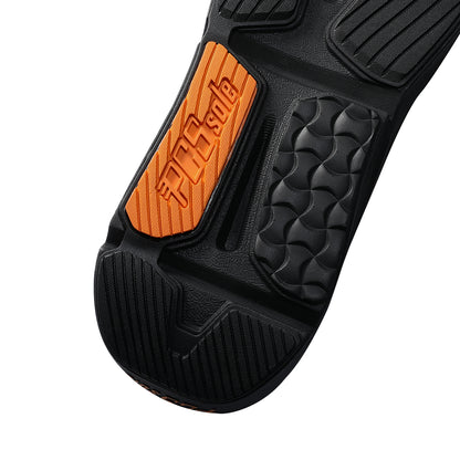 Close-up of a black athletic shoe sole with a bright orange accent panel featuring the embossed brand name 'PCSsole'.